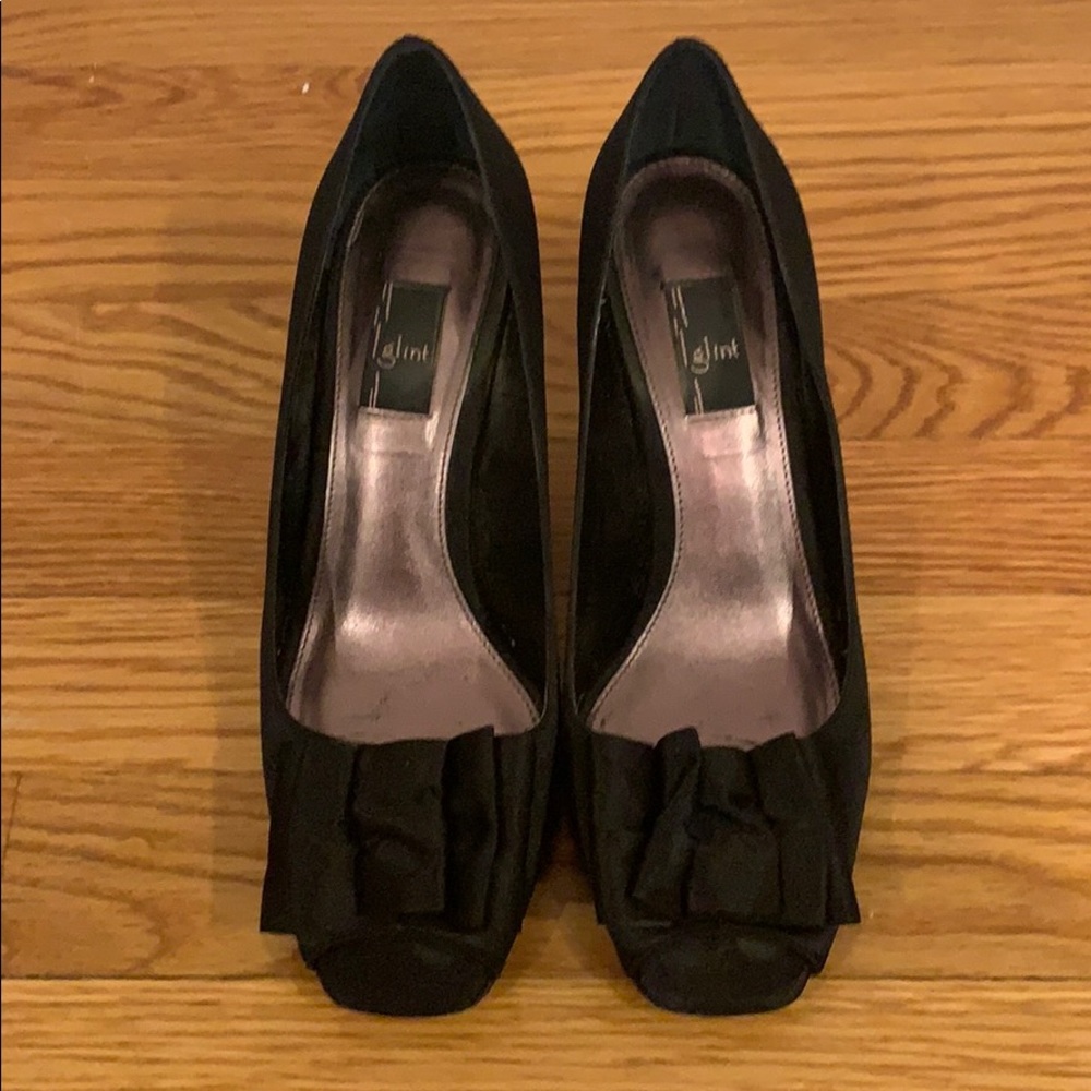 Peep toe black satin dress pump with bow detail.